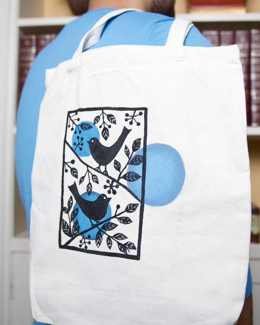 Birdies tote: two birds on leafy branches inside a blue frame
