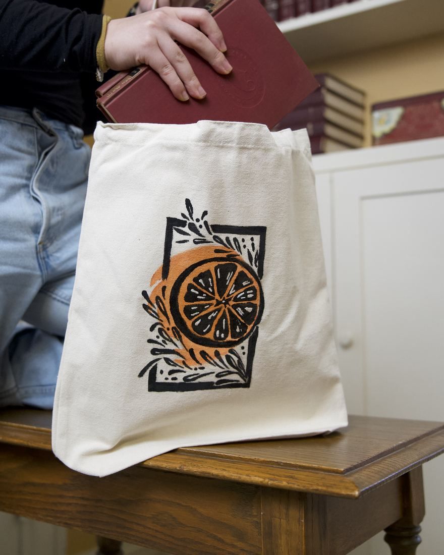 Citrus tote: a sliced orange with leaves in a block-print square