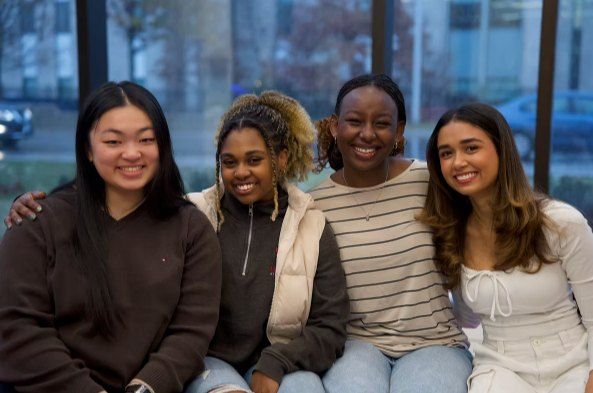 Frances, Riya, Cindy and Ally sitting together and smiling